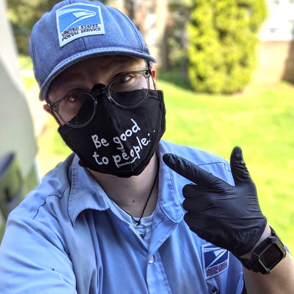 Mail person wearing a Be Good To People mask