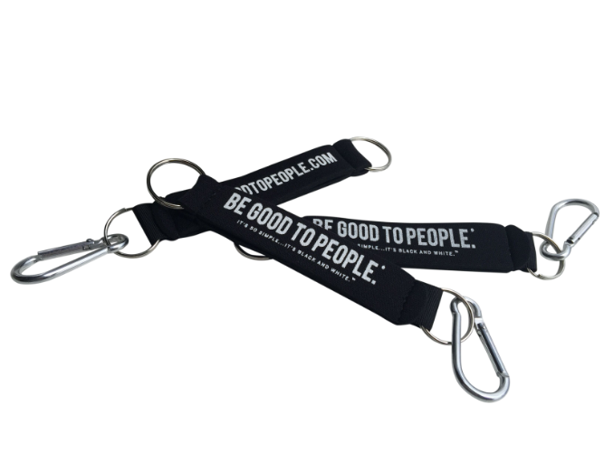 Black Neoprene Key Ring or Holder with Carabiner Clip on one end and key ring. Stap parts and hand can slip through so it can be worn on wrist.
